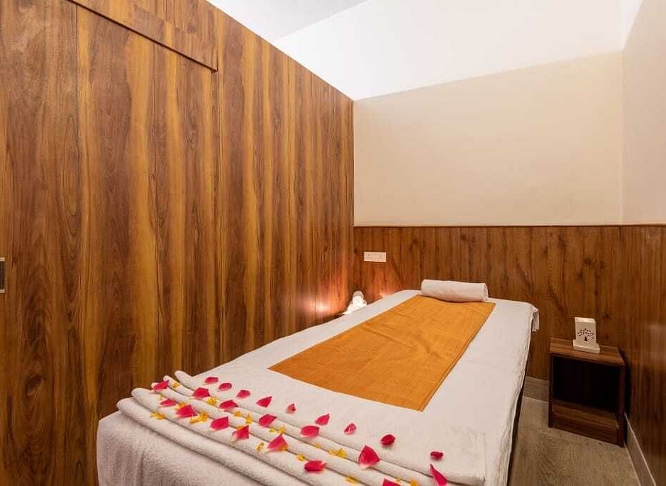 Image of a spa bed with candles on the table  | DLS Serenity Resort and Spa